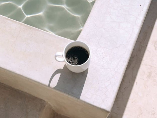 Blog Post graphic - Recession Proof Your Online Store - Cup of coffee by a swimming pool